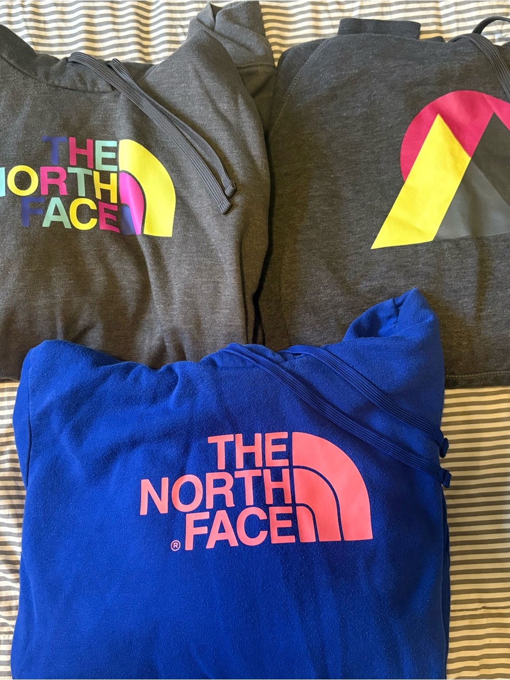 The North Face Charcoal & Royal Blue Hoodies with Neon Logos
